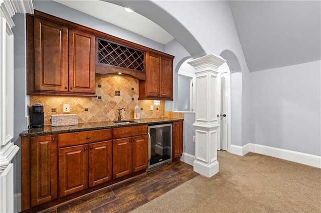 4080 Glen Hill Way NE, Marietta, GA 30066 - indoor wet bar with wine cooler, dark colored carpet, arched walkways, tasteful backsplash, and decorative columns