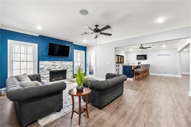4080 Glen Hill Way NE, Marietta, GA 30066 - living room with a fireplace, a ceiling fan, ornamental molding, baseboards, and light wood-style floors