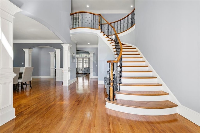 4080 Glen Hill Way NE, Marietta, GA 30066 - entryway featuring arched walkways, ornate columns, a towering ceiling, stairway, and crown molding
