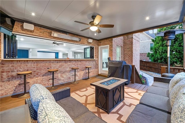 4080 Glen Hill Way NE, Marietta, GA 30066 - living room with ceiling fan, light wood finished floors, and brick wall