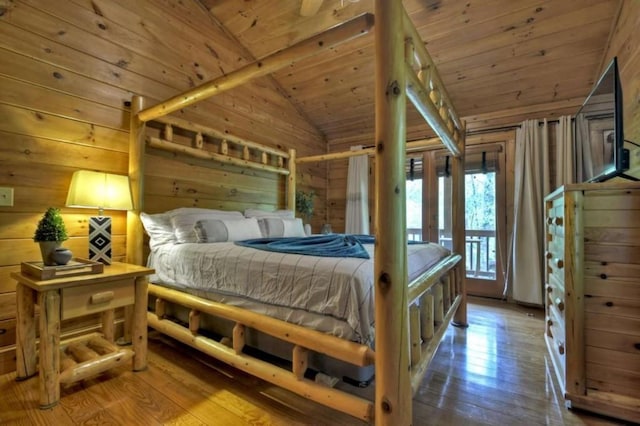 bedroom with wooden walls, wood-type flooring, wood ceiling, and vaulted ceiling