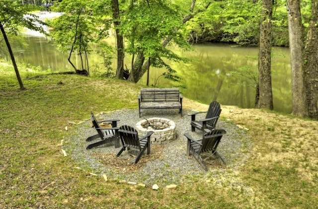 view of yard featuring a fire pit and a water view