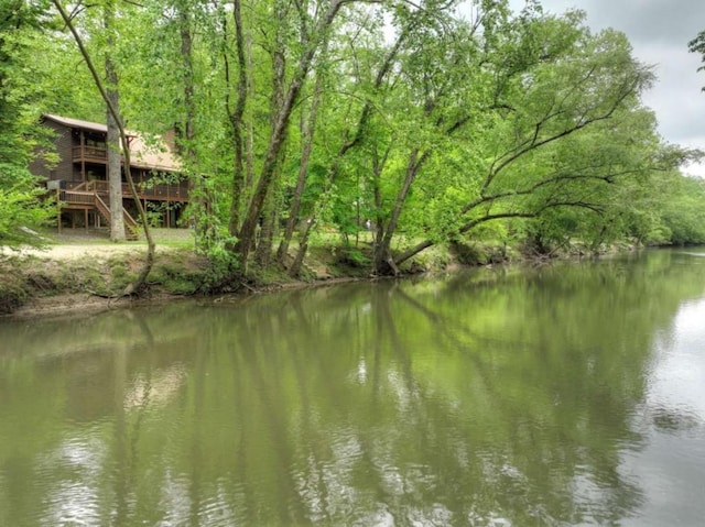 property view of water featuring a wooded view