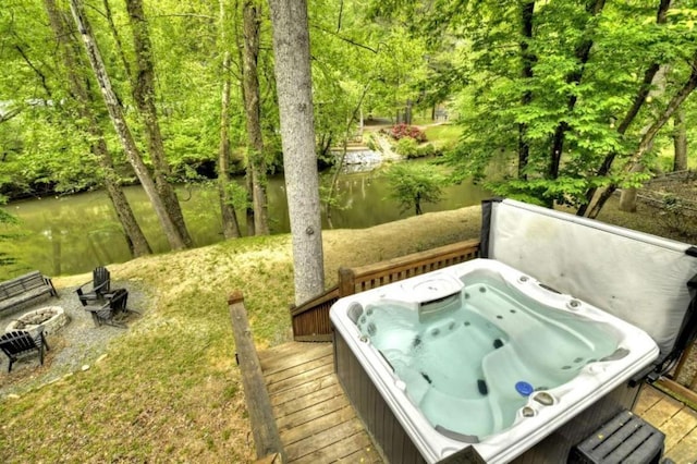 wooden deck with a covered hot tub
