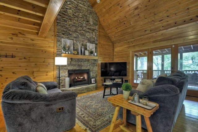 living area with a wealth of natural light, wooden walls, wood finished floors, and wood ceiling