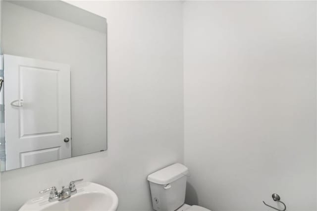 bathroom with toilet and sink