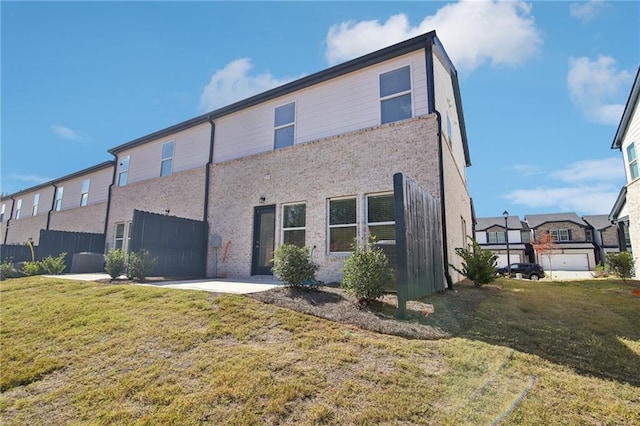 back of house with a lawn and a patio area