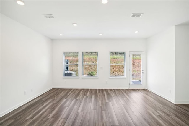 spare room featuring dark wood-type flooring