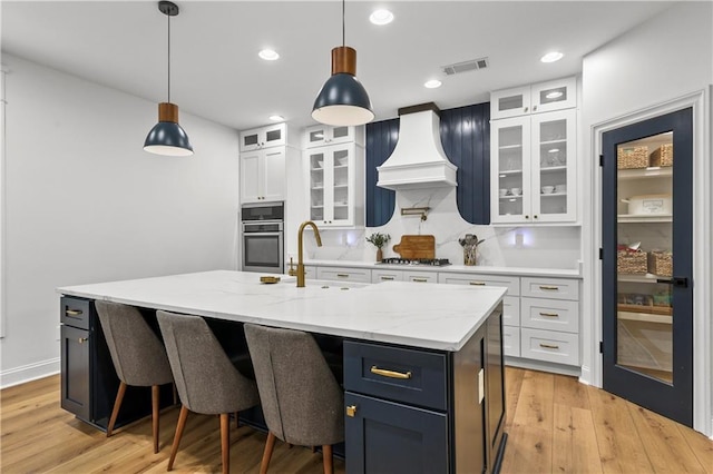 2013 White Cypress Ct, Smyrna, GA 30082 - kitchen featuring a sink, white cabinets, light wood-type flooring, custom exhaust hood, and recessed lighting
