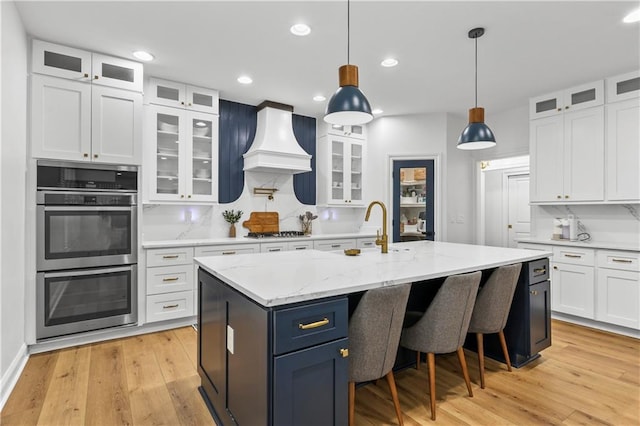 2013 White Cypress Ct, Smyrna, GA 30082 - kitchen with stainless steel double oven, custom exhaust hood, white cabinetry, gas stovetop, and recessed lighting