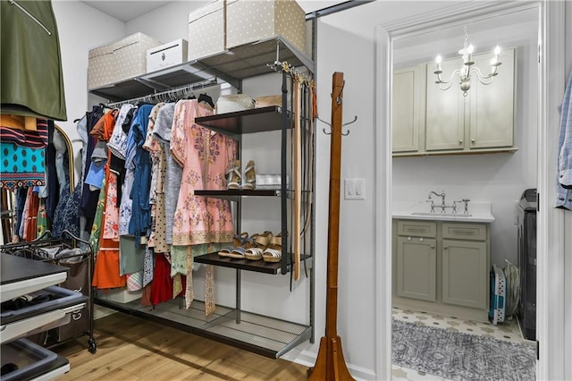 2013 White Cypress Ct, Smyrna, GA 30082 - spacious closet featuring a sink, light wood-style floors, and a chandelier