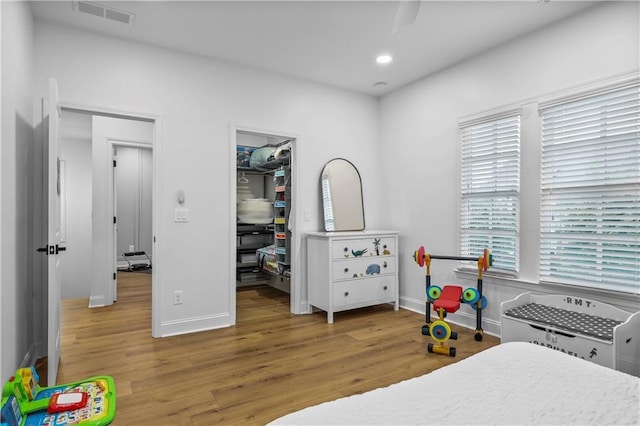 2013 White Cypress Ct, Smyrna, GA 30082 - bedroom with wood finished floors, baseboards, a walk in closet, and recessed lighting