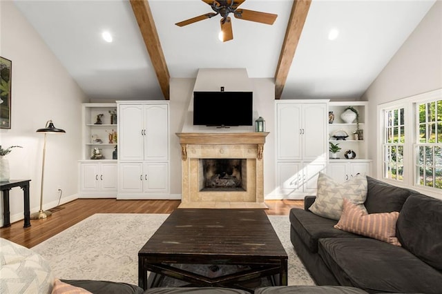 living area with ceiling fan, a premium fireplace, wood finished floors, recessed lighting, and baseboards