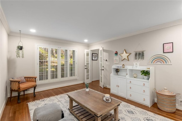 living area featuring ornamental molding, wood finished floors, baseboards, and recessed lighting