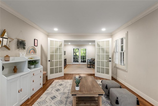 living room with french doors, wood finished floors, ornamental molding, baseboards, and recessed lighting