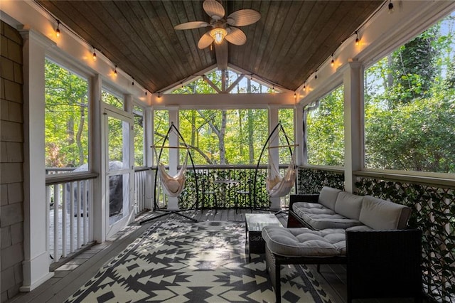 sunroom / solarium featuring outdoor lounge area, a ceiling fan, and lofted ceiling