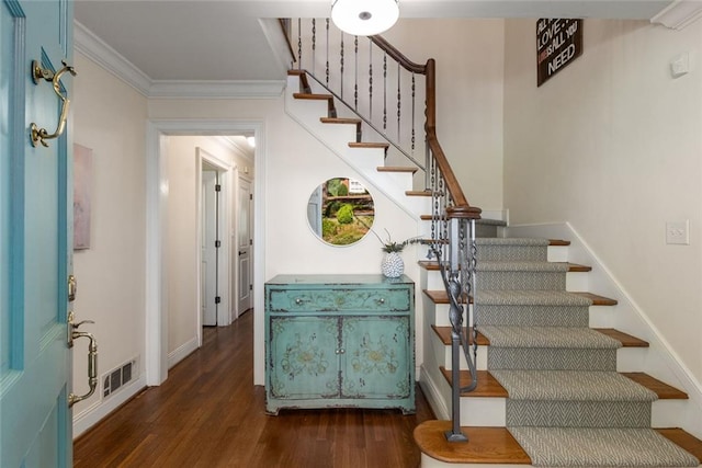 stairs featuring wood finished floors, ornamental molding, and baseboards