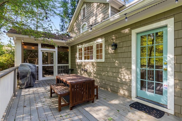 wooden deck with a grill