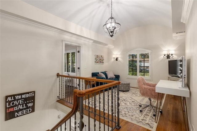 office area with vaulted ceiling, a chandelier, and wood finished floors