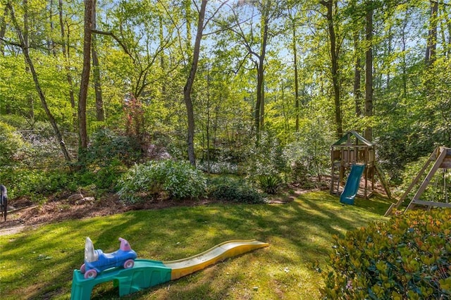 view of grassy yard with a playground