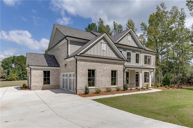 craftsman house featuring a front yard and a garage