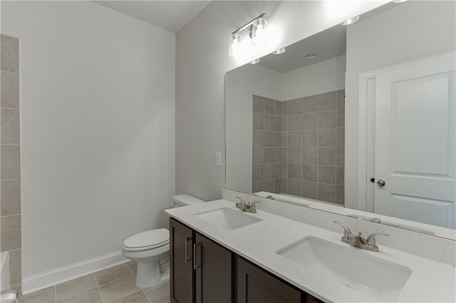 bathroom with vanity, toilet, and tile patterned flooring