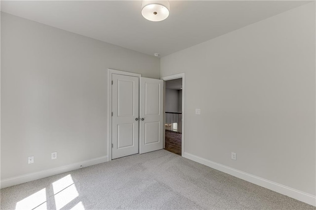 unfurnished bedroom featuring light carpet