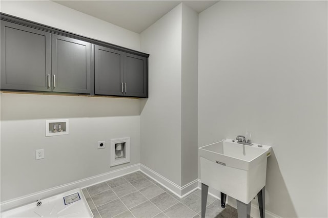 washroom with washer hookup, light tile patterned floors, sink, cabinets, and electric dryer hookup