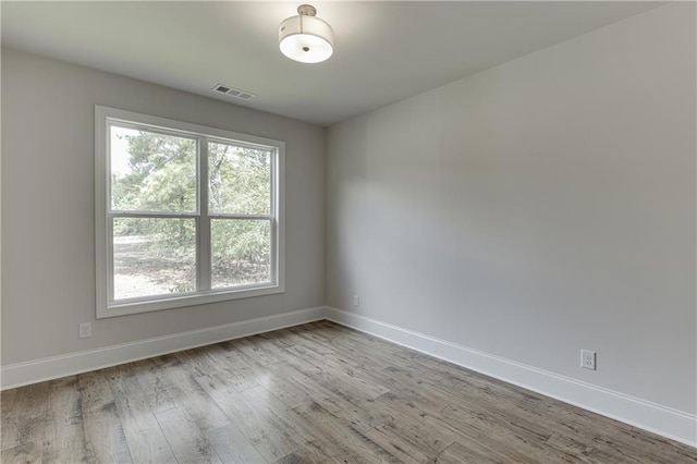 spare room with light hardwood / wood-style floors