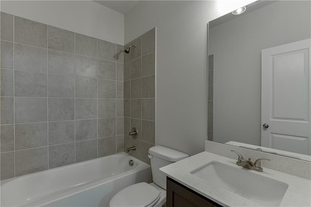 full bathroom with toilet, vanity, and tiled shower / bath combo