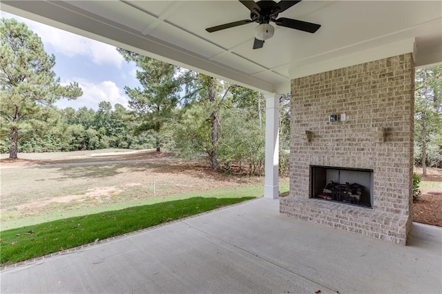 view of patio / terrace with ceiling fan and an outdoor brick fireplace