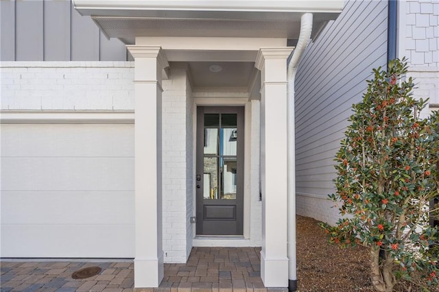 view of exterior entry with a garage