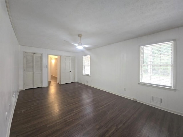 2821 NE Meadowlark Trl, Duluth, GA 30096 - unfurnished bedroom with dark wood-type flooring, multiple windows, and baseboards