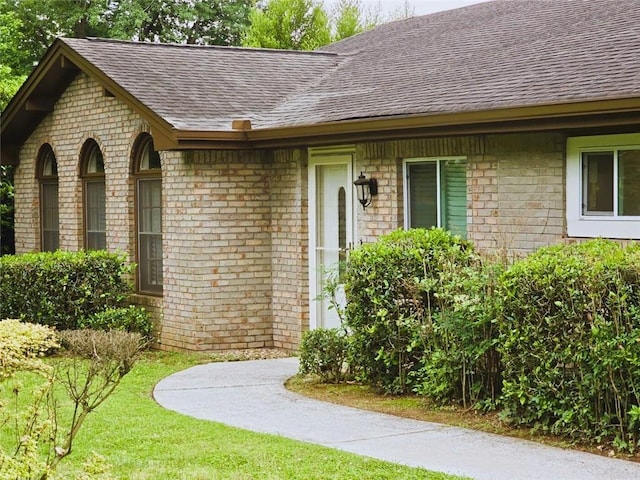 2821 NE Meadowlark Trl, Duluth, GA 30096 - doorway to property with roof with shingles, brick siding, and a lawn