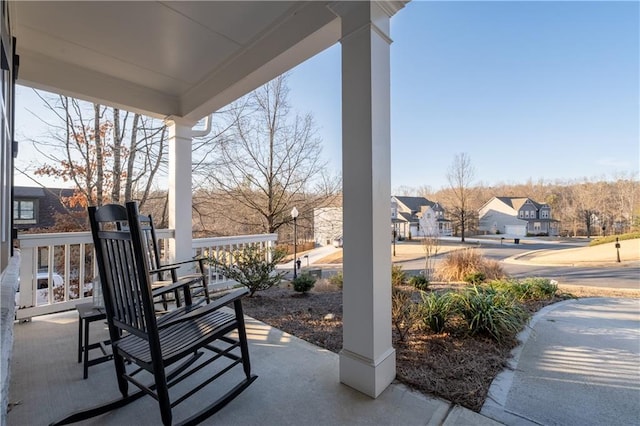 view of patio / terrace with a porch and a residential view
