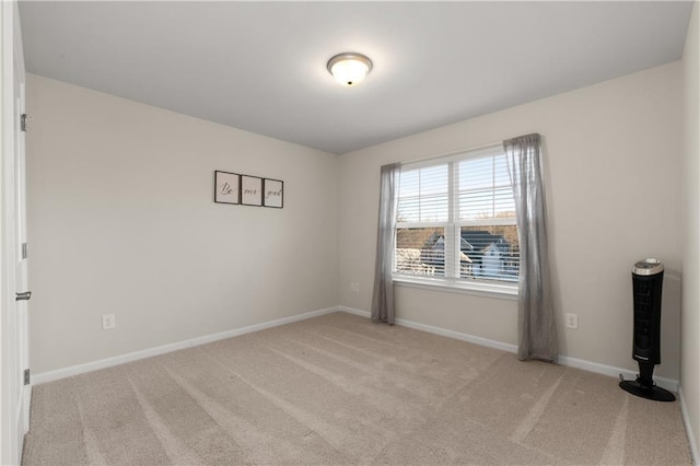 unfurnished room with baseboards and carpet floors
