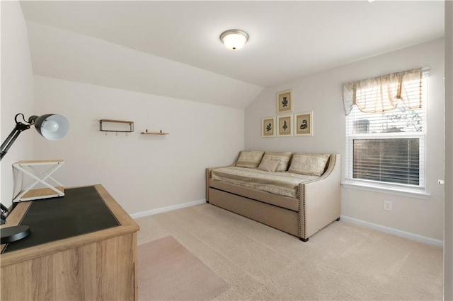 interior space with baseboards, light carpet, and vaulted ceiling