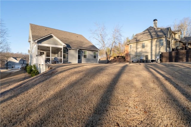 back of house with ceiling fan