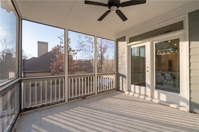 unfurnished sunroom with a ceiling fan