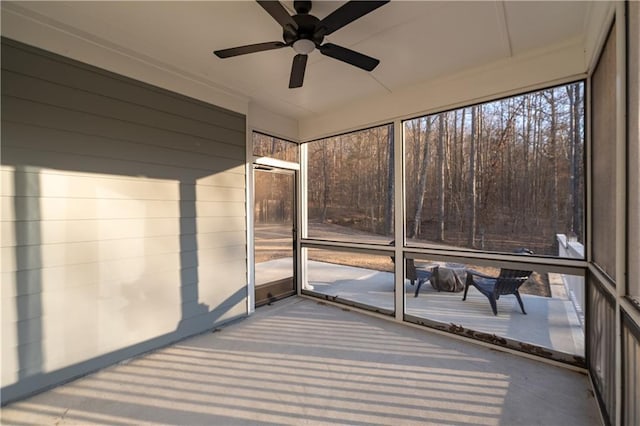 unfurnished sunroom featuring ceiling fan