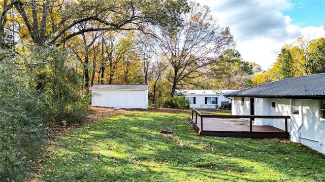 view of yard with a shed and a wooden deck