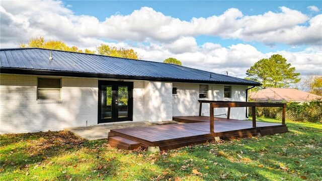 back of property featuring french doors and a wooden deck