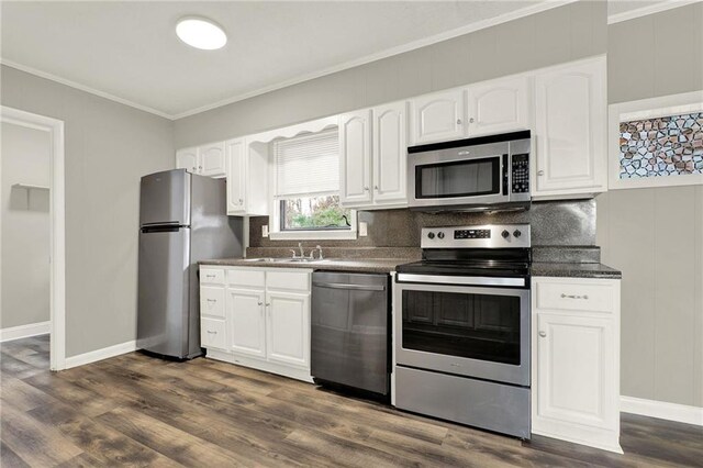 kitchen with white cabinets, stainless steel appliances, and dark hardwood / wood-style floors