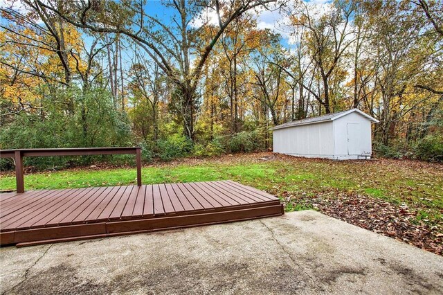 view of yard featuring a storage shed and a deck