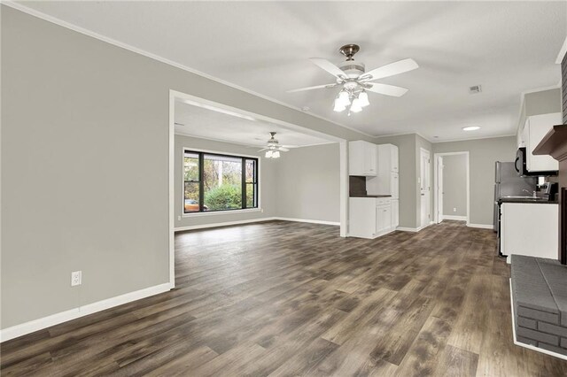 unfurnished living room with dark hardwood / wood-style floors, ceiling fan, and ornamental molding