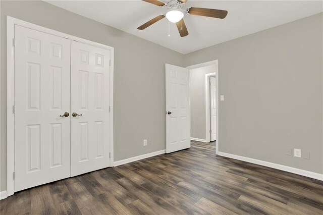 unfurnished bedroom featuring a closet, dark hardwood / wood-style floors, and ceiling fan