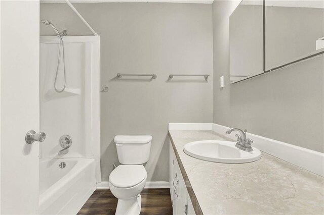 full bathroom with vanity, hardwood / wood-style flooring, toilet, and tub / shower combination