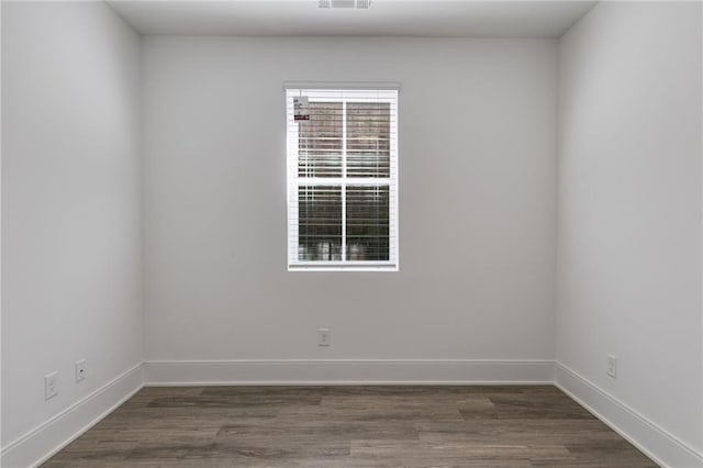 unfurnished room featuring dark wood-type flooring