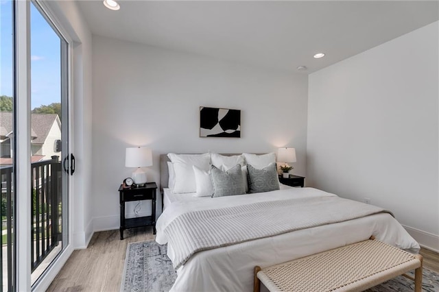 bedroom featuring access to outside and light hardwood / wood-style flooring