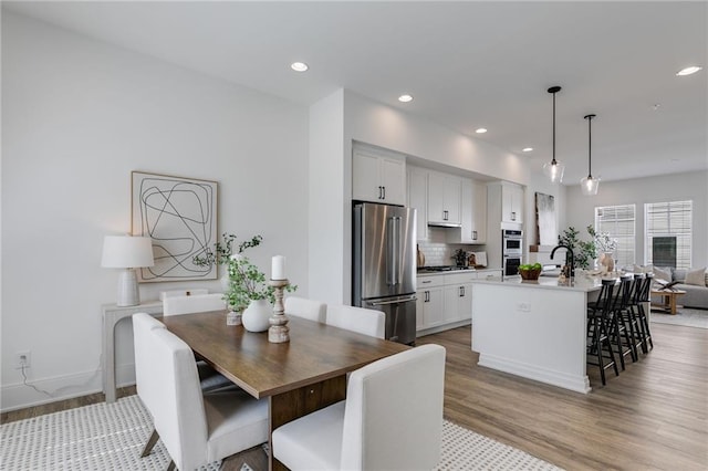 dining space with light wood-type flooring